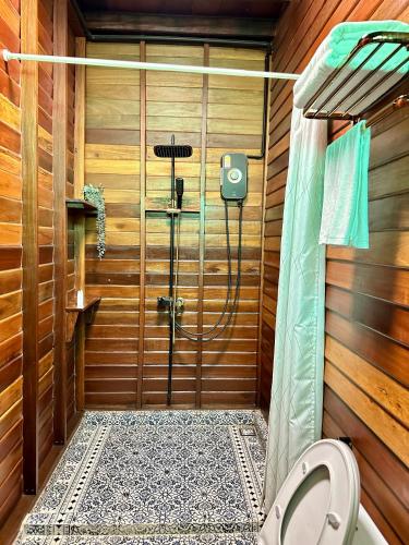 a bathroom with a shower with a toilet in it at RuenKijja in Ban Kroen