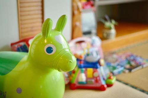 a green toy horse sitting on top of a table at 広い庭付きBBQ可,残波ビーチまで車で5分,最大人数11名 Ns garden in Jima