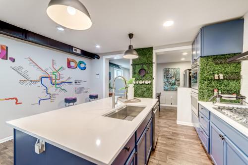 a kitchen with a sink and blue cabinets at TheWrightStays Art Haven at Fairlawn Gardens in Washington