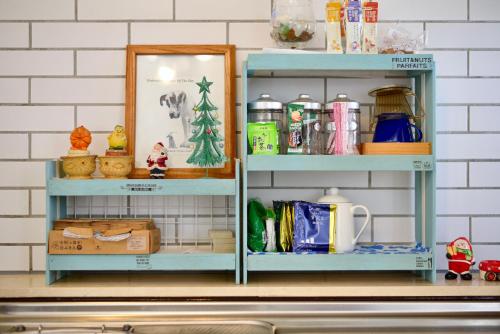 a shelf above a kitchen counter with items on it at 広い庭付きBBQ可,残波ビーチまで車で5分,最大人数11名 Ns garden in Jima