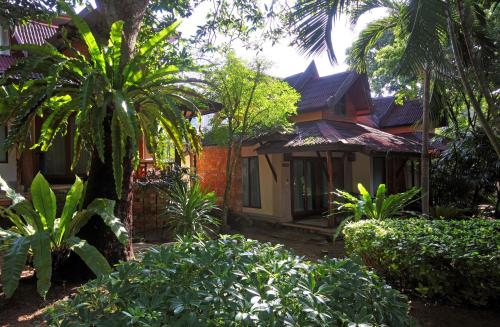a house with trees and plants in front of it at Sand Sea Resort Railay Beach in Railay Beach