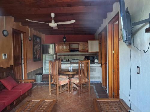 a kitchen with a table and chairs in a room at Hotel Villas San Miguel in Pátzcuaro