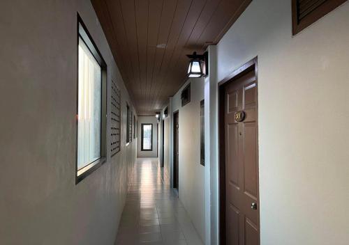 an empty hallway with a ceiling and a door at Srichada Hotel Khaolak - SHA Extra Plus in Khao Lak