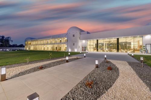 a rendering of a building at dusk at Western Hotel Liwa in Liwa