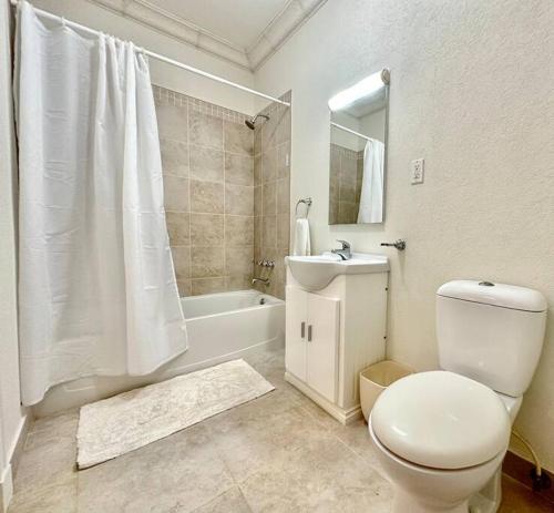 a white bathroom with a toilet and a sink at 122 Vuemont Resorts in Saint Peter