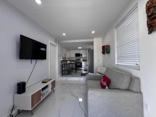 a living room with a couch and a flat screen tv at Charming two bedroom apartment. in Miami