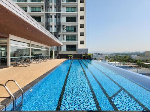 a swimming pool on the roof of a building at FOX Hotel Glenmarie Shah Alam in Shah Alam