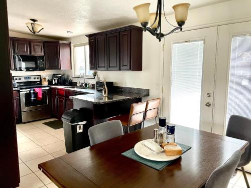 a kitchen with a wooden table and a dining room at Mountain View in Salt Lake City