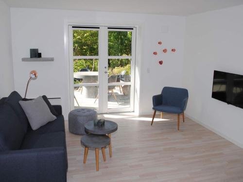 a living room with a couch and a table at 4 person holiday home in Allinge in Allinge