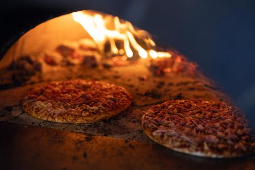 two pizzas are being cooked in an oven at NRMA Dubbo Holiday Park in Dubbo