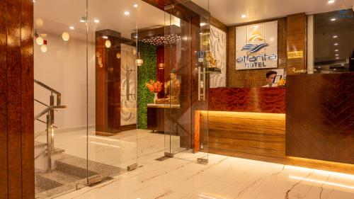 a lobby of a restaurant with a glass wall at Hotel Atlanta - A Seaview Hotel in Port Blair