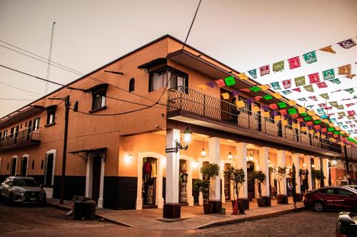 a building with flags on the side of it at Copa de Oro Hotel Boutique in Mascota