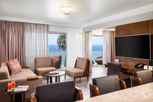 a living room with a television and a living room with a couch at Crowne Plaza Fiji Nadi Bay Resort & Spa by IHG in Nadi