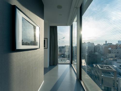 a room with a large window with a view of a city at Kaname Inn Tatemachi in Kanazawa