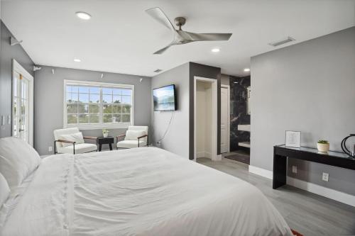 a bedroom with a large bed with a ceiling fan at Escondida Drive in West Palm Beach