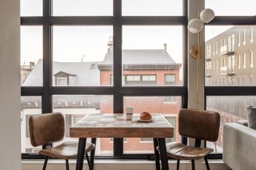 a table and two chairs in front of a window at Sosuite at The Vine - Old City in Philadelphia
