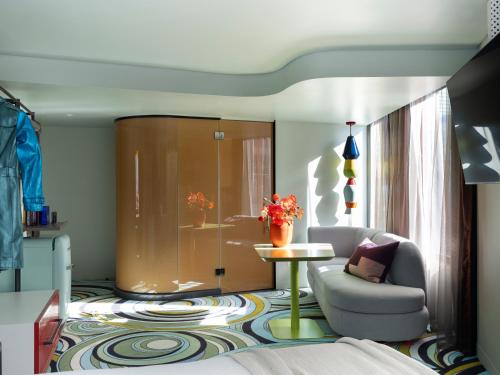 a living room with a couch and a table at Adge Hotel and Residences in Sydney