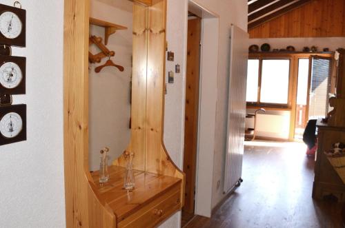 a room with a mirror and a wooden dresser at Chalet Memory in Zermatt