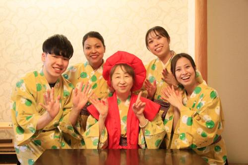a group of people in kimonos posing for a picture at Yuyado Mikannoki in Atami