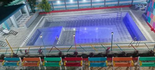 a large swimming pool with blue and red at HSV WONDER WORLD,FARM HOUSES in Venkatāpur