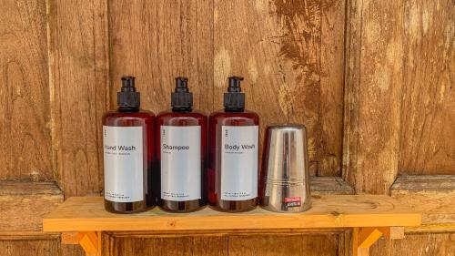 a group of three fire extinguishers sitting on a wooden shelf at Yukke Tembi Homestay in Yogyakarta