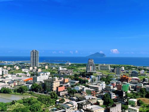 a city with the ocean in the background at 光嶼海溫泉海景無邊際泳池豪華套房 in Hsin-hsing