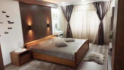 a bedroom with a large bed in a room at Cuza 21 in Brăila