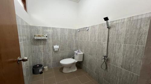 a bathroom with a toilet and a shower at Wijaya Hostel in Denpasar