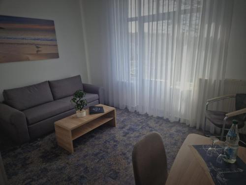a living room with a couch and a coffee table at Villa Ludwigsburg in Kühlungsborn