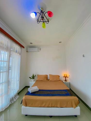Ένα ή περισσότερα κρεβάτια σε δωμάτιο στο Rumah palala