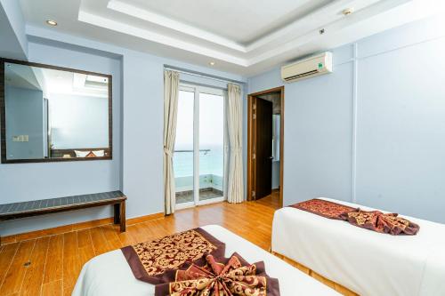 Postel nebo postele na pokoji v ubytování Ocean Waves Resort Cam Ranh