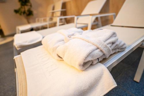 a pile of towels sitting on a hospital bed at Anin Park Hotel in Warsaw