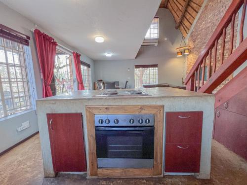 a kitchen with a stove and a counter top at Walking Tall Private Bush Retreat in Marloth Park