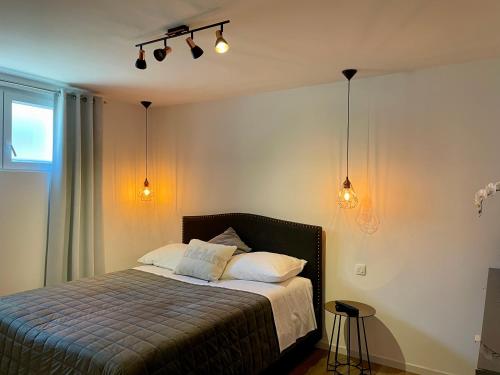 a bedroom with a bed and two lights on the wall at Sea View Kozino in Kožino