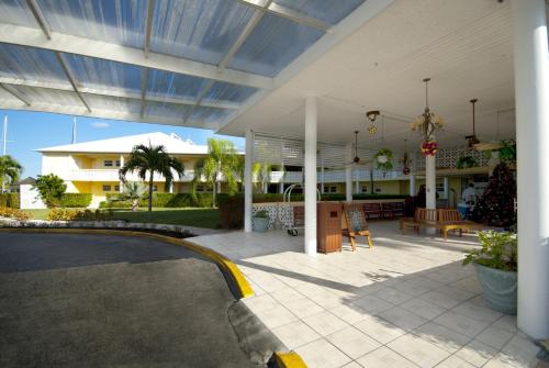 a building with a covered patio with a table at Ocean Reef Yacht Club & Resort in Freeport