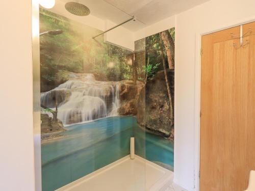 a room with a waterfall mural on the wall at River Walk in Kendal