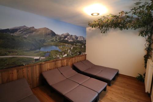a room with a view of a mountain mural on the wall at Aparthotel Pichler in Flachau