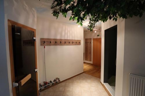 a hallway with a wall with shoes on it at Aparthotel Pichler in Flachau