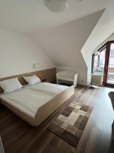 a bedroom with a bed and a large window at Hotel Sonne by Mastiff in Bad Wildbad