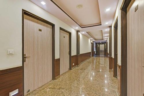 a corridor of a building with a door and a hallway at Collection O Hotel Airport View in Jaipur