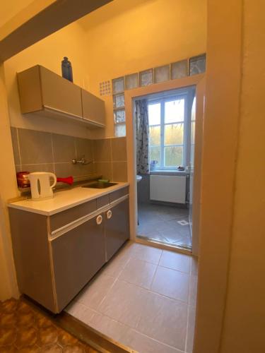 a kitchen with a sink and a counter top at Tilia Ház in Salgótarján