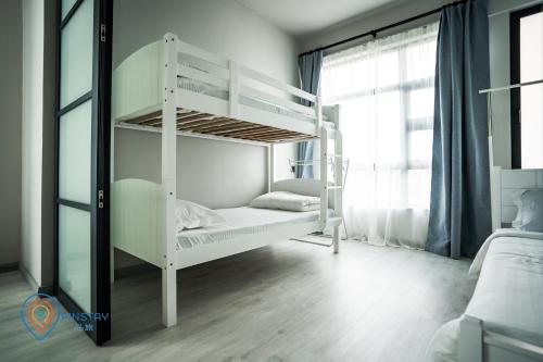 a white bunk bed in a room with a window at Jesselton Quay by Pinstay in Kota Kinabalu