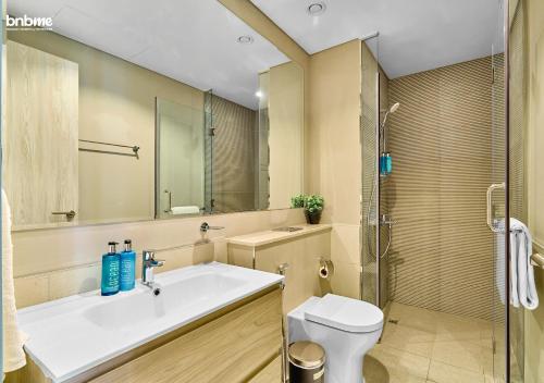 a bathroom with a sink and a toilet and a shower at bnbmehomes - Business Bay Beauty w/ City Views - 1816 in Dubai