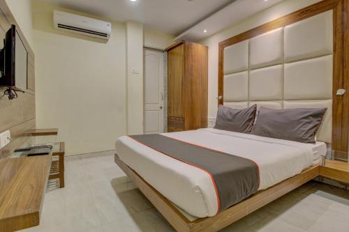 a bedroom with a large bed and a television at OYO Hotel Address Inn in Mumbai
