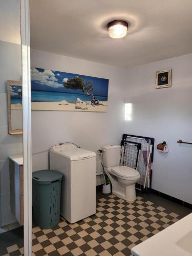 a bathroom with a toilet and a checkered floor at Maison 4 face a la mer grand Jardin Ideal Famille avec pluri Animaux Saint Clair Le Lavandou in Le Lavandou