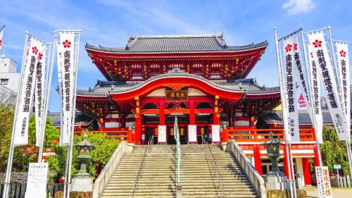 a large red building with steps in front at Toyoko Inn Nagoya Nishiki in Nagoya