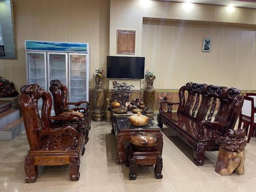 a living room with wooden furniture and a tv at Hải Vân Hotel - 488 Võ Nguyên Giáp, Điện Biên Phủ - by Bay Luxury in Diện Biên Phủ