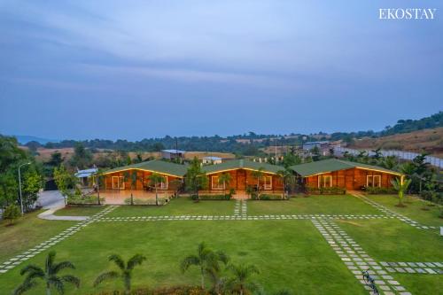 an aerial view of a house with a yard at EKOSTAY Luxe - Woodstock Villa I 2 Acre Property I Cricket Turf I Party Friendly in Karjat
