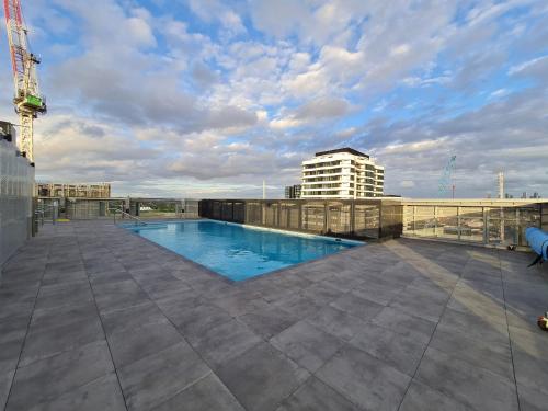 a swimming pool on the roof of a building at Panoramic Views 2BR with Pool and Free carpark in Melbourne
