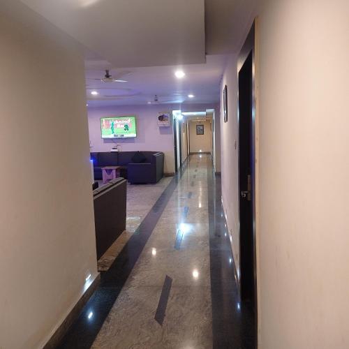 a hallway leading to a living room with a couch at Hotel Shubh Ashish Near Bank More in Dhanbād